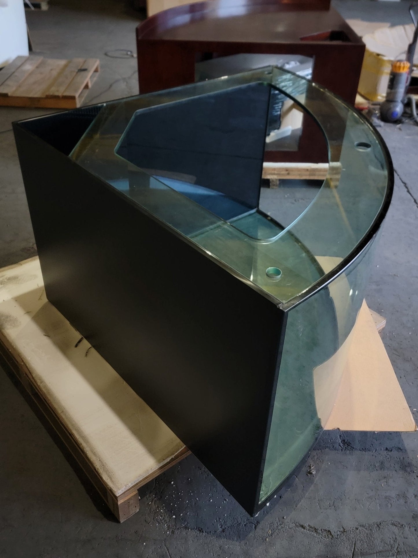 Black and clear glass aquarium on a concrete floor