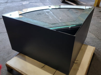Black metal fire pit with glass top on a concrete surface