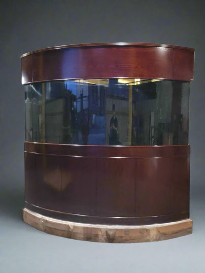 Curved glass display case with wooden frame on a gray background