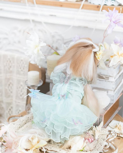 Light blue dress with ruffles on a white surface