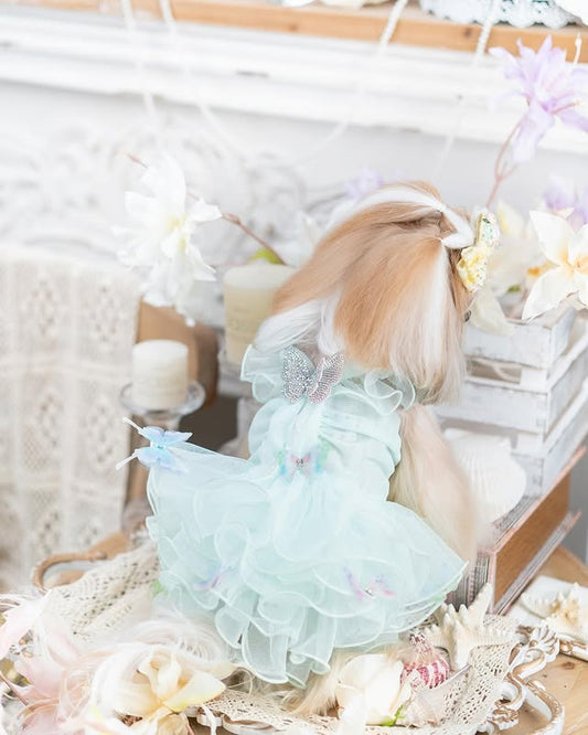 Light blue dress with ruffles on a white surface