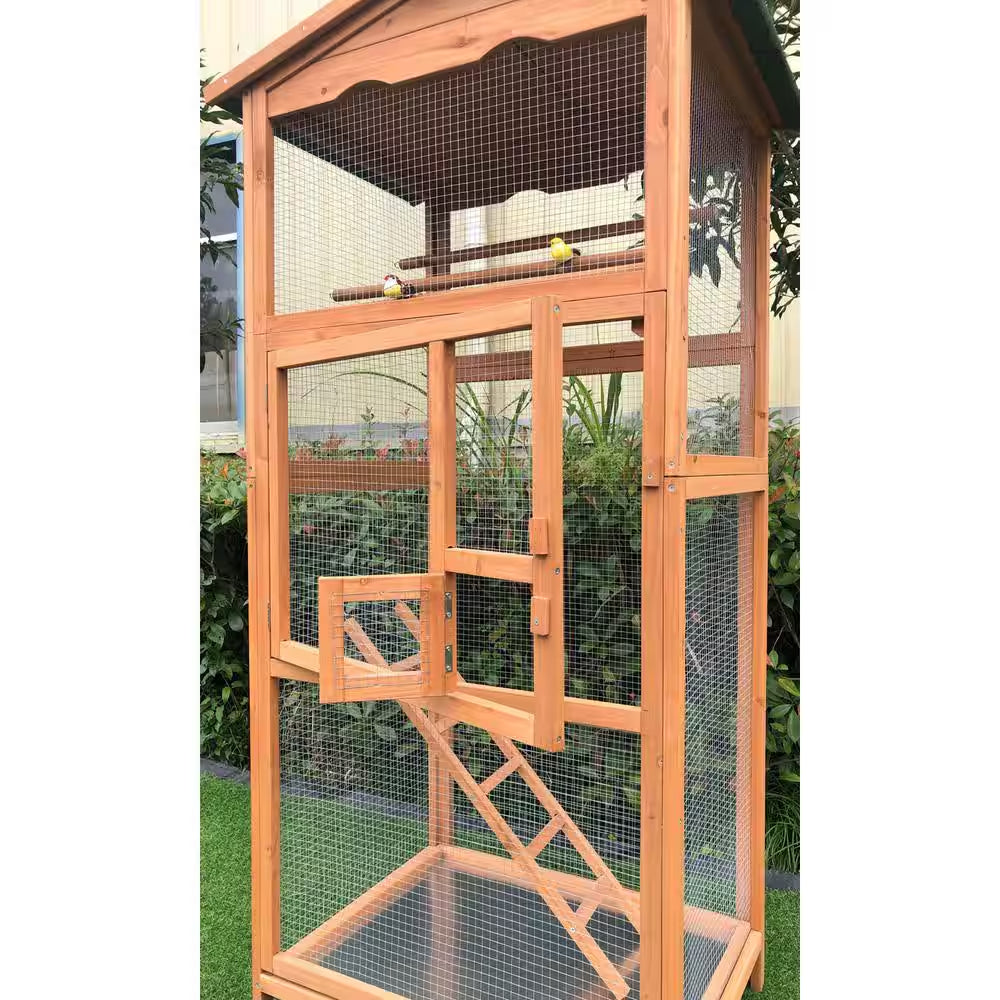 Wooden bird cage with mesh sides and a ladder, set against a natural background.