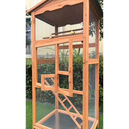 Wooden bird cage with mesh sides and a ladder, set against a natural background.