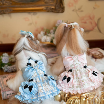 Two dolls with styled hair and dresses in a decorative setting