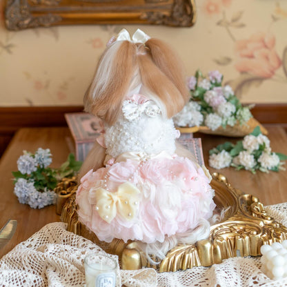 Decorative figure with floral dress on a table with flowers and lace