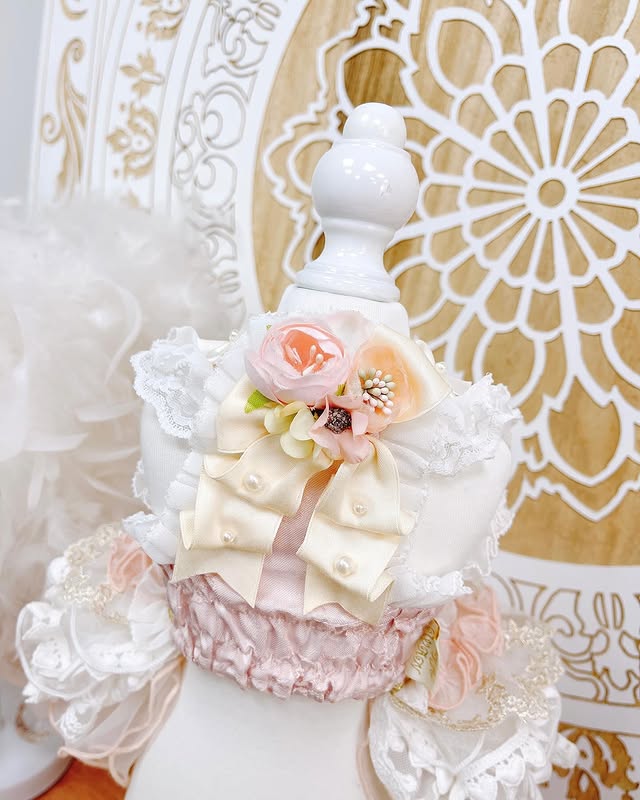 Decorative white vase with floral arrangements on a decorative background