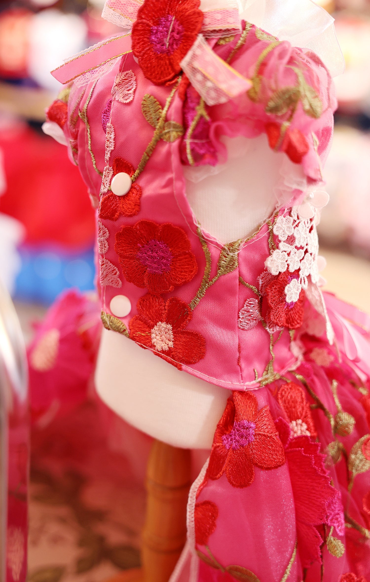 Traditional pink and red embroidered garment with floral patterns