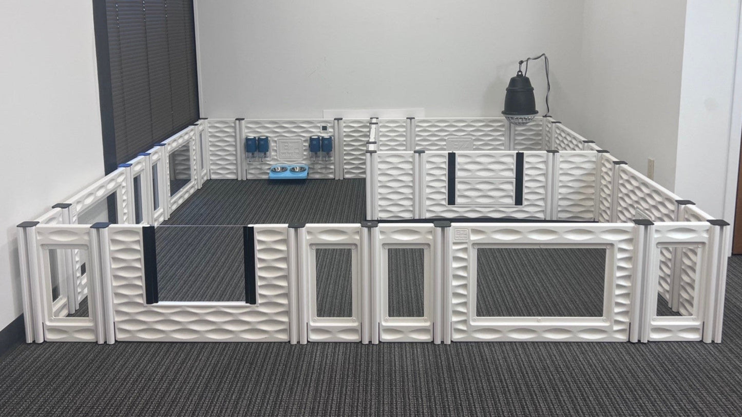 Pet playpen with multiple sections on a carpeted floor.