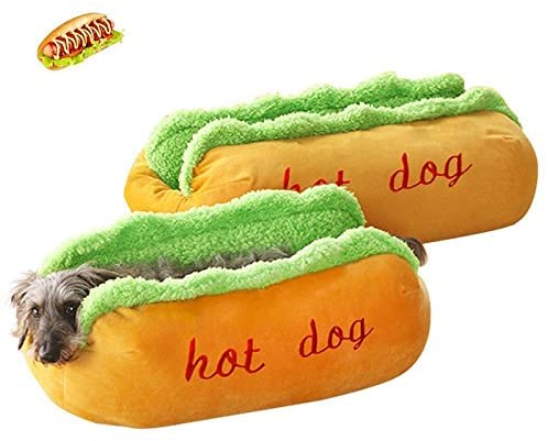 Dog lying in a hot dog-shaped pillow with green relish and 'hot dog' text.