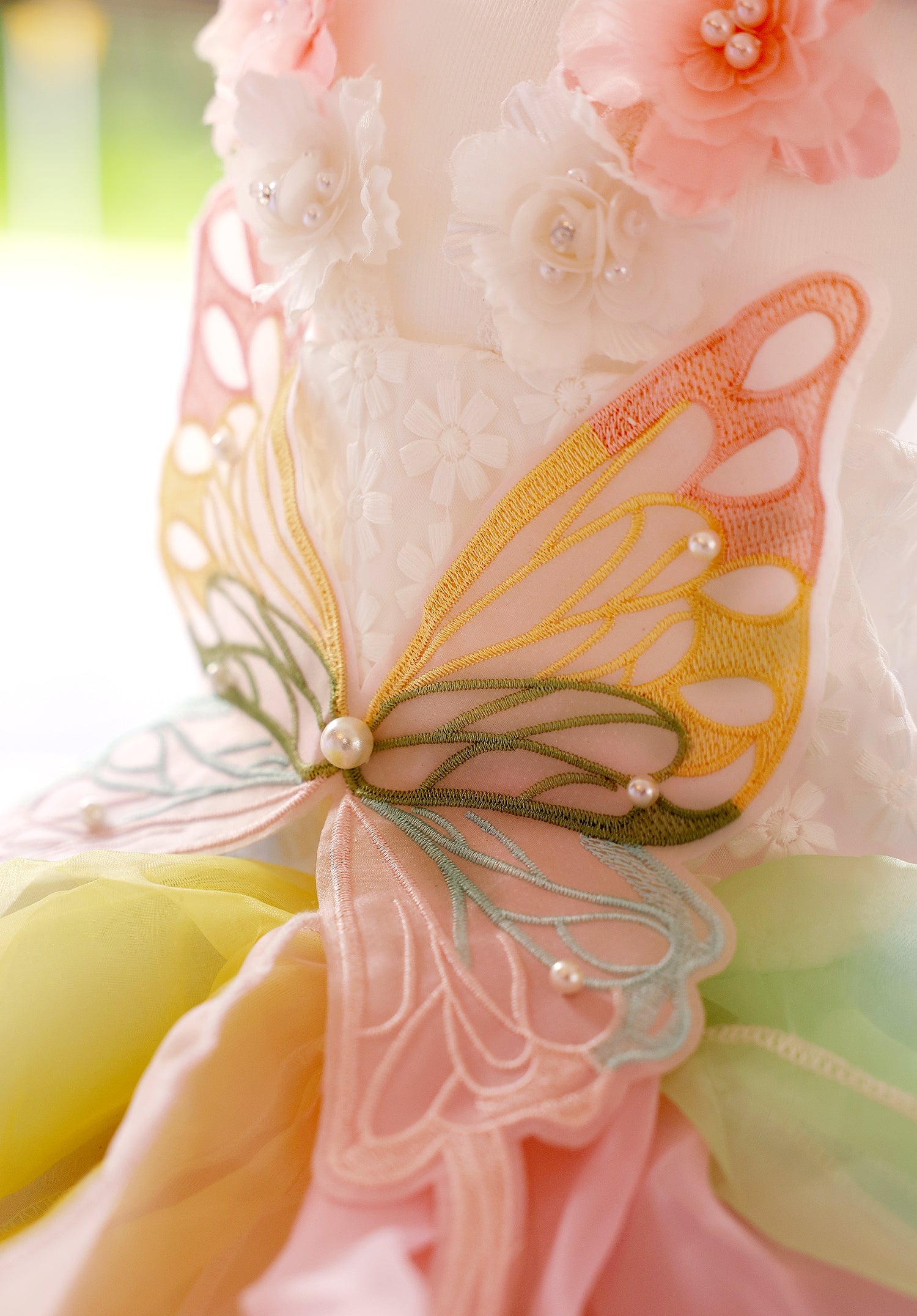Close-up of a decorative item with butterfly wings and floral elements.