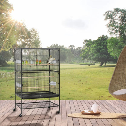 Large bird cage on a wooden deck with a scenic background of trees and grass.