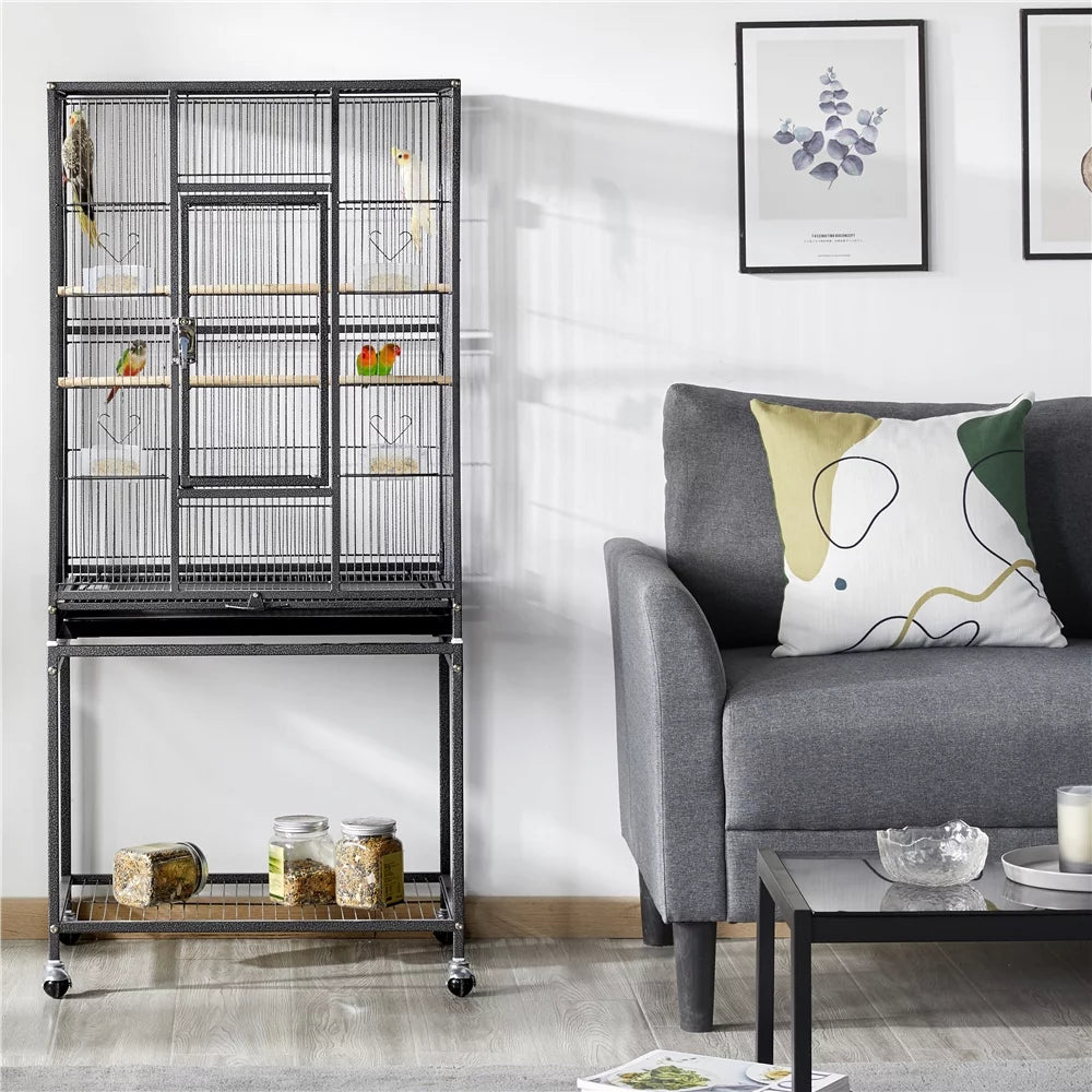 Birdcage next to a gray sofa in a living room setting