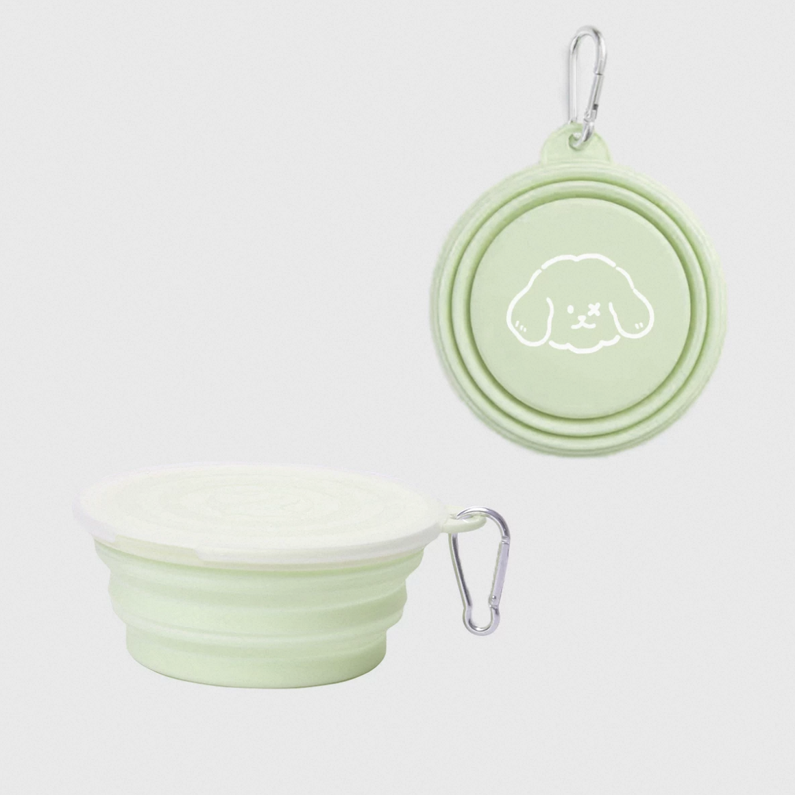 Light green silicone travel bowl and lid with a cute dog design on a white background