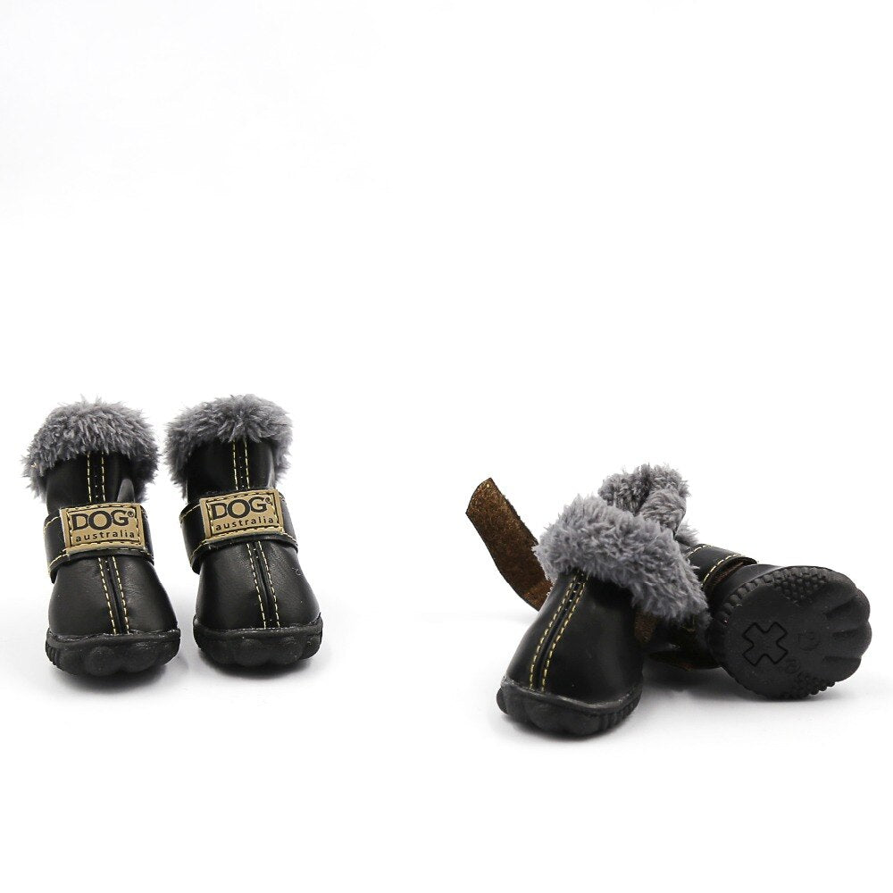 Pair of black dog boots with gray fur trim on a white background