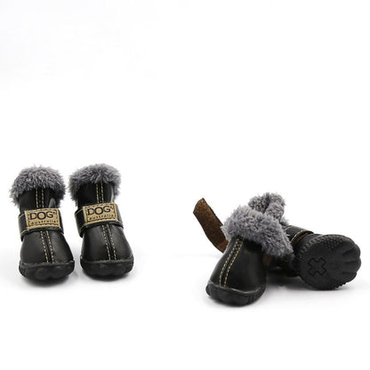 Pair of black dog boots with gray fur trim on a white background