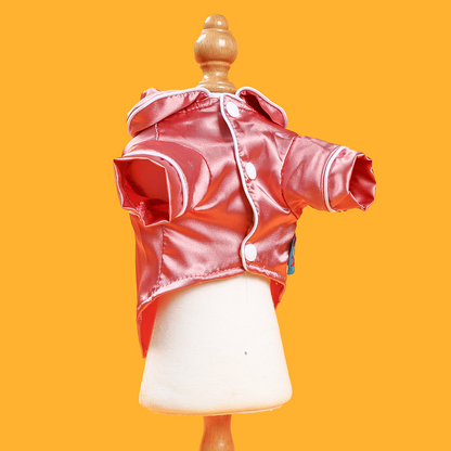 Red satin jacket on a mannequin against an orange background