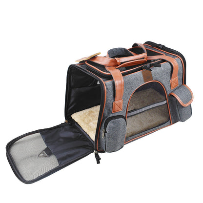 Pet carrier with brown leather straps on a white background
