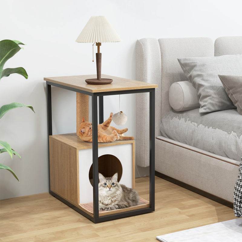 Wooden cat立体house with two cats inside, placed on a side table in a living room.
