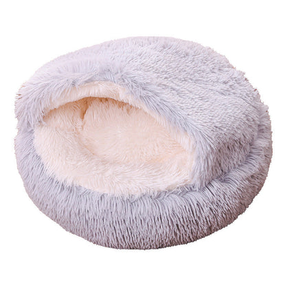 Fluffy pet bed with gray exterior and cream interior on a white background