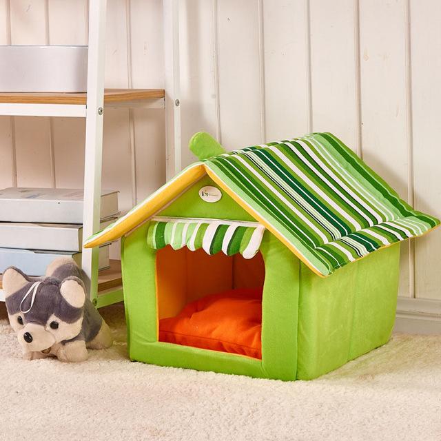 Green pet house with striped roof in a room setting