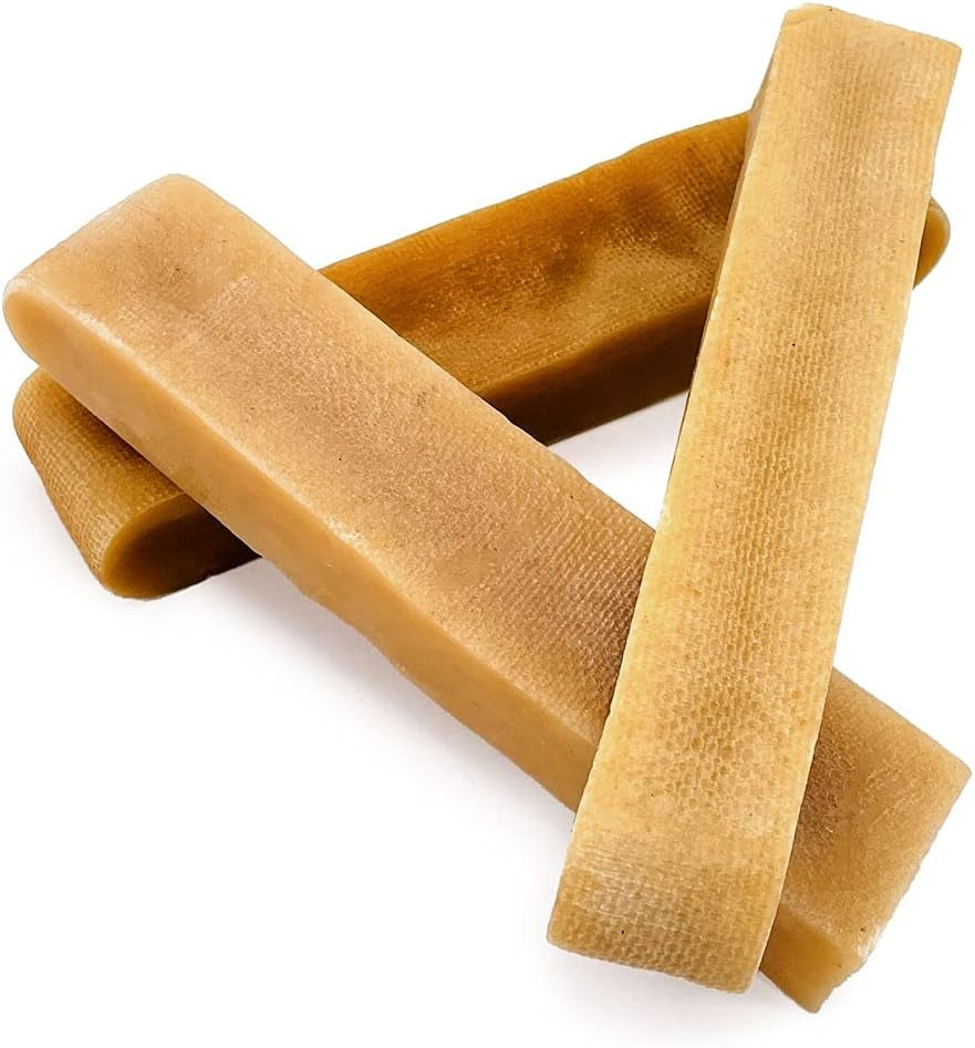 Three brown dog chew treats on a white background
