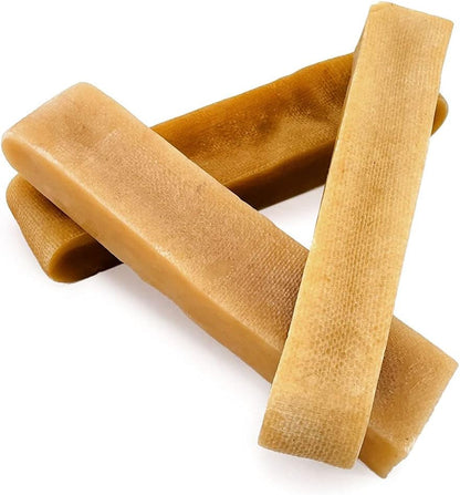 Three brown dog chew treats on a white background