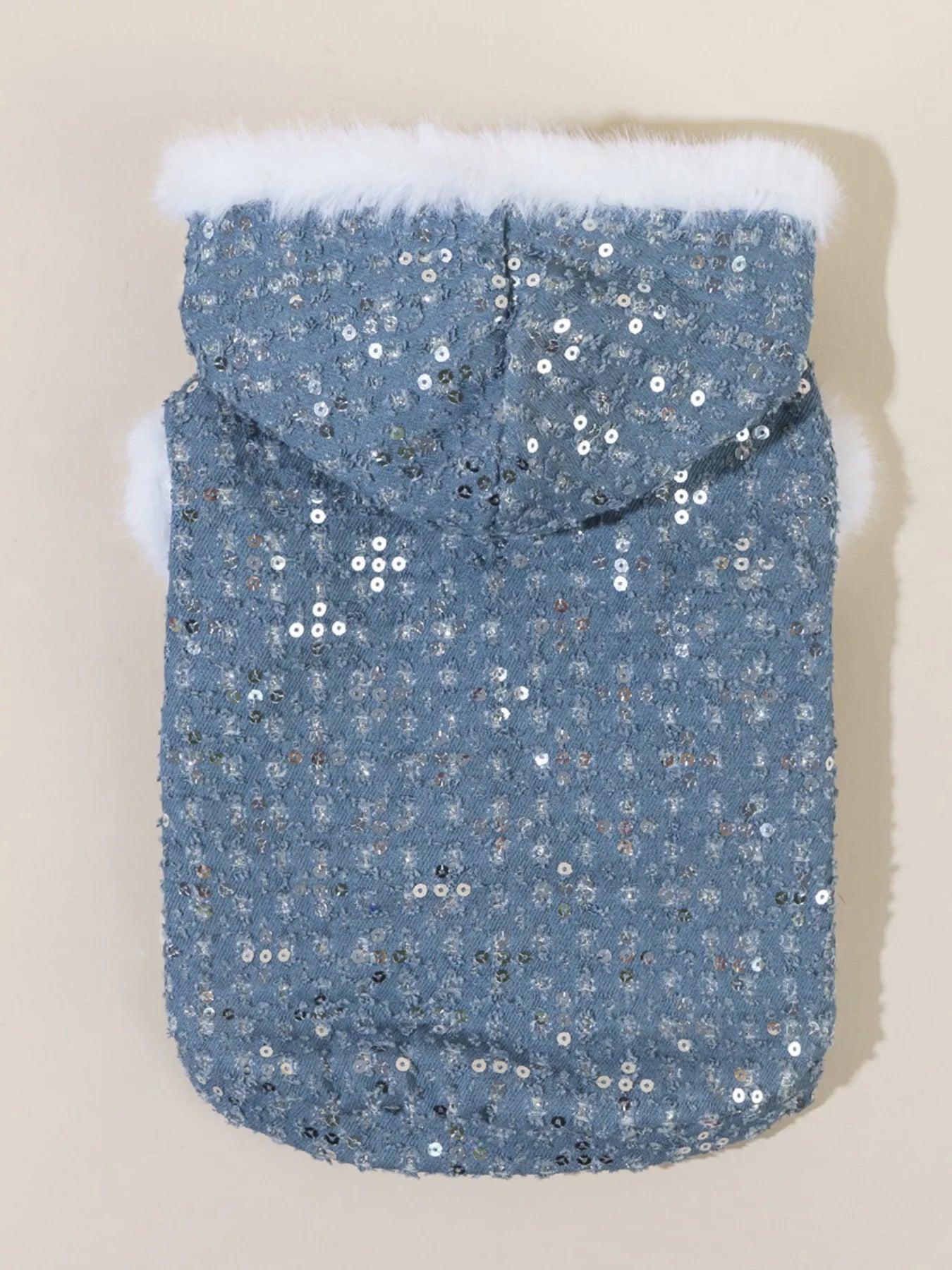 Blue sequin dog coat with white fur trim on a beige background