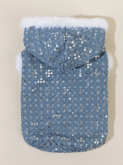 Blue sequin dog coat with white fur trim on a beige background