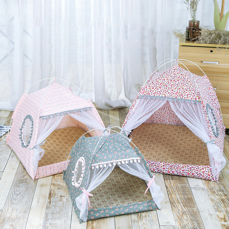 Three pet tents with floral and polka dot patterns on a wooden floor.