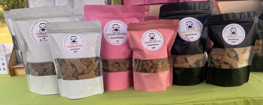 Assorted bags of dried fruits on a green surface with visible brand labels.