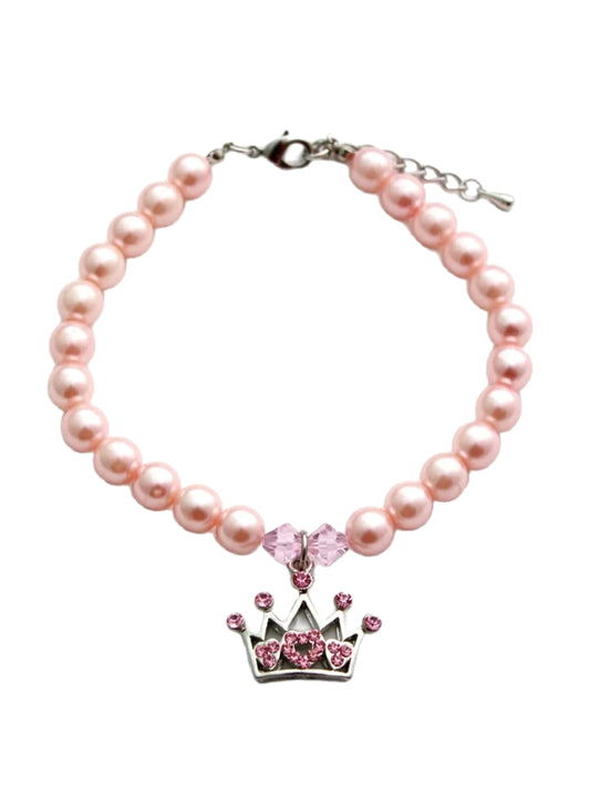 Pink pearl bracelet with a crown charm on a white background