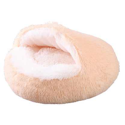 Plush pink pet bed with white interior on a white background