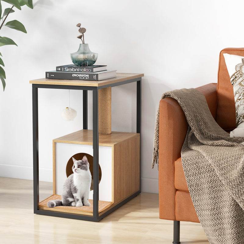 Wooden side table with a cat inside, next to a brown sofa with a blanket.