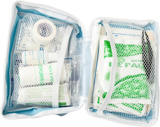 Contents of pet first aid kit separated, on a white background