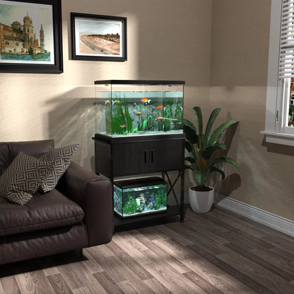 Living room with a fish tank on a stand, plants, and framed pictures.