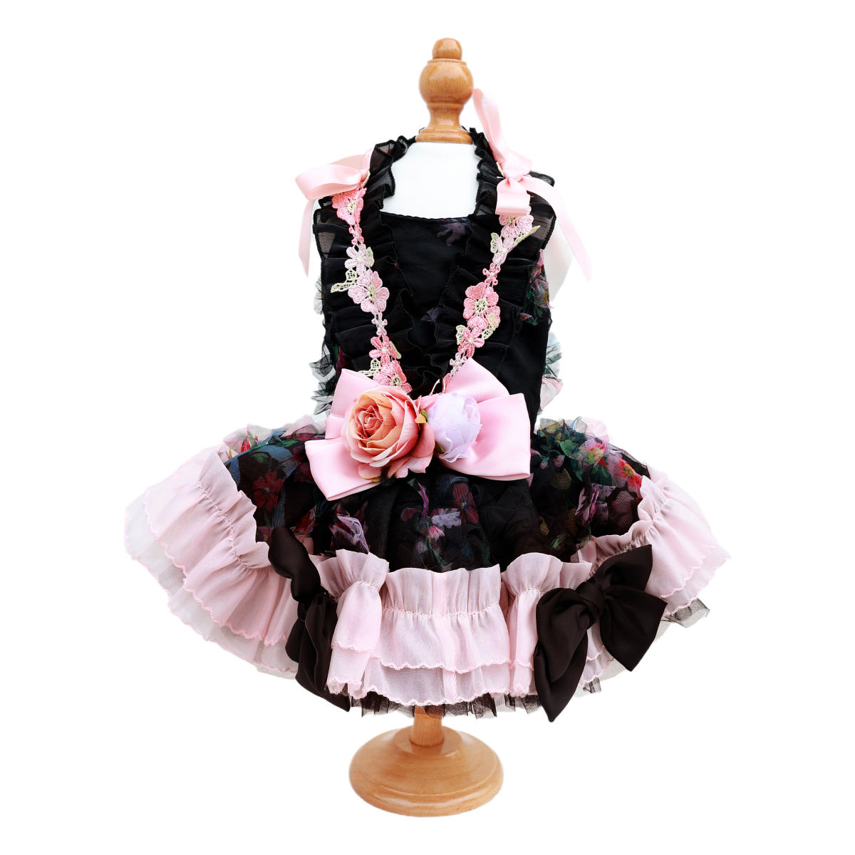 Children's dress with floral details on a mannequin against a white background