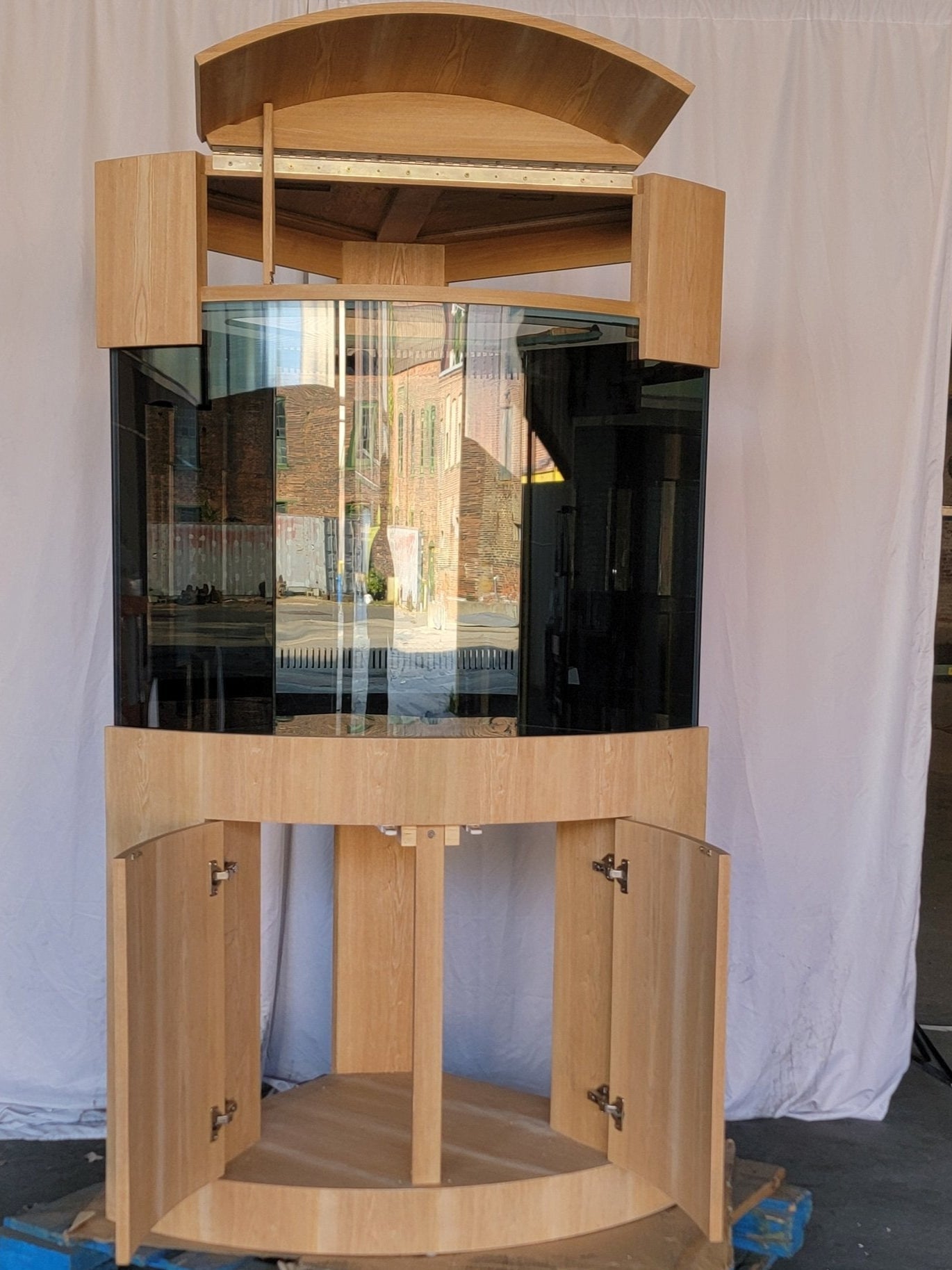 Wooden fish tank with glass front on a white background