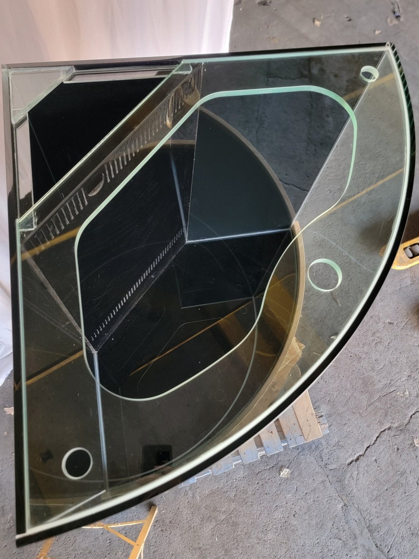 Glass table with geometric design on a concrete floor