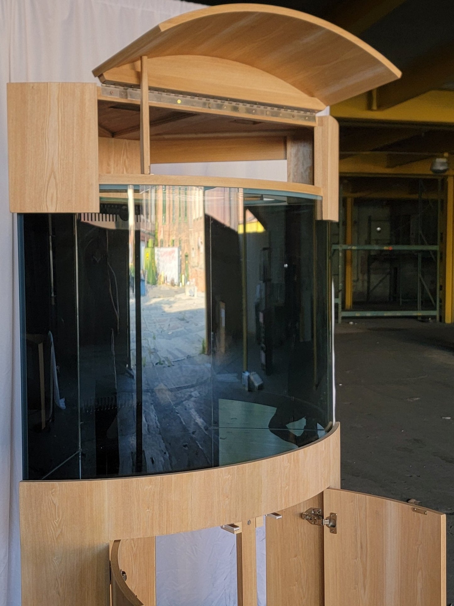 Wooden outdoor canopy with glass panel in an industrial setting