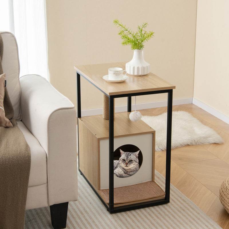 Small wooden side table with a cat peeking out, placed next to a sofa in a living room.