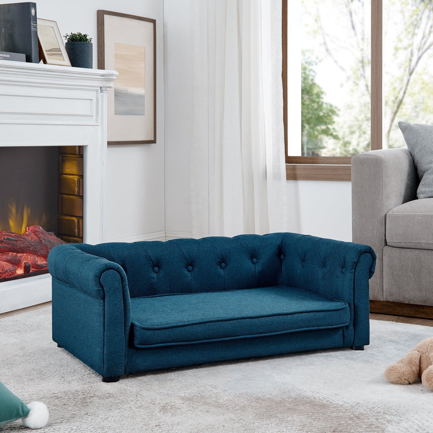 Blue sofa in a living room with a fireplace and window