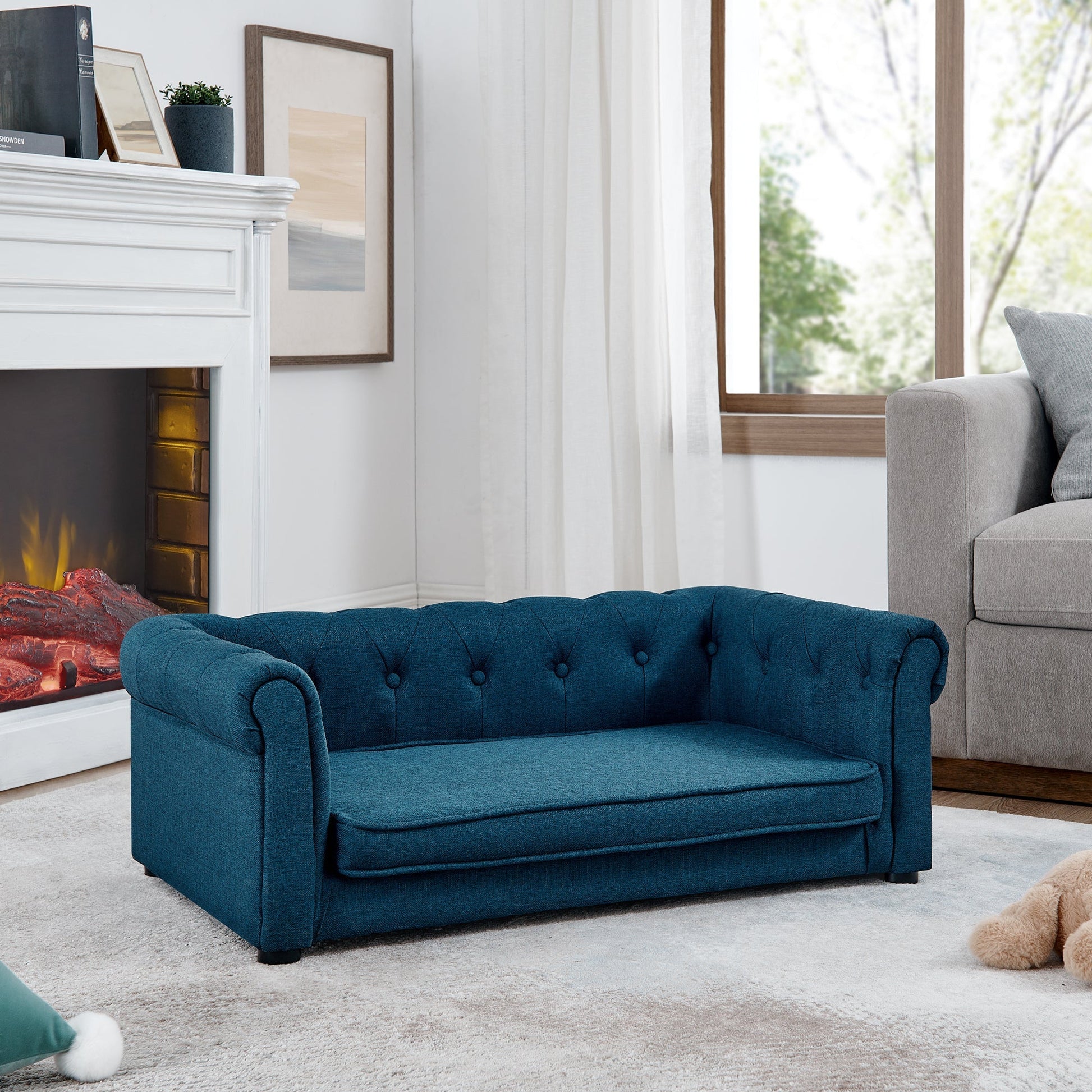 Blue sofa in a living room with a fireplace and window