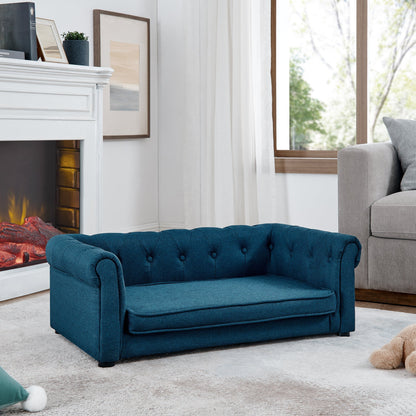 Blue sofa in a living room with a fireplace and window