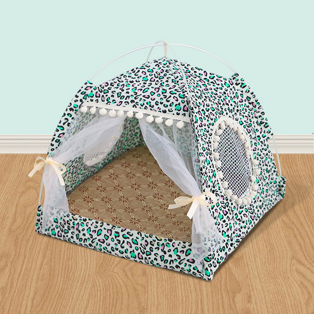 Pet tent with leopard print design on a wooden floor against a light blue wall.