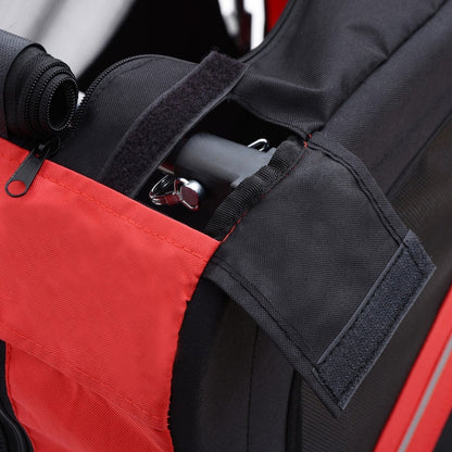 Close-up of a red and black bag with a strap and zipper detail.