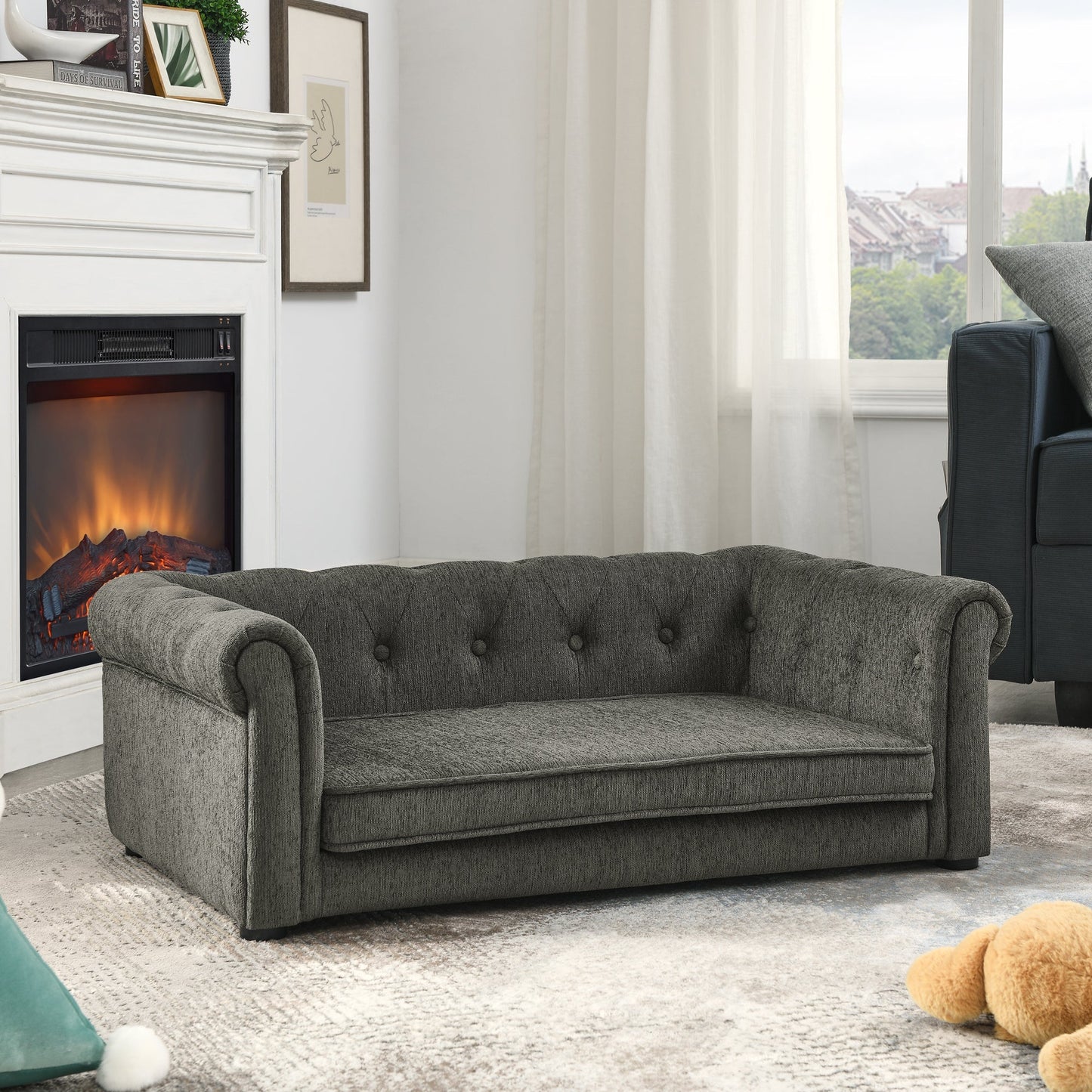 Gray sofa in a living room with a fireplace and window