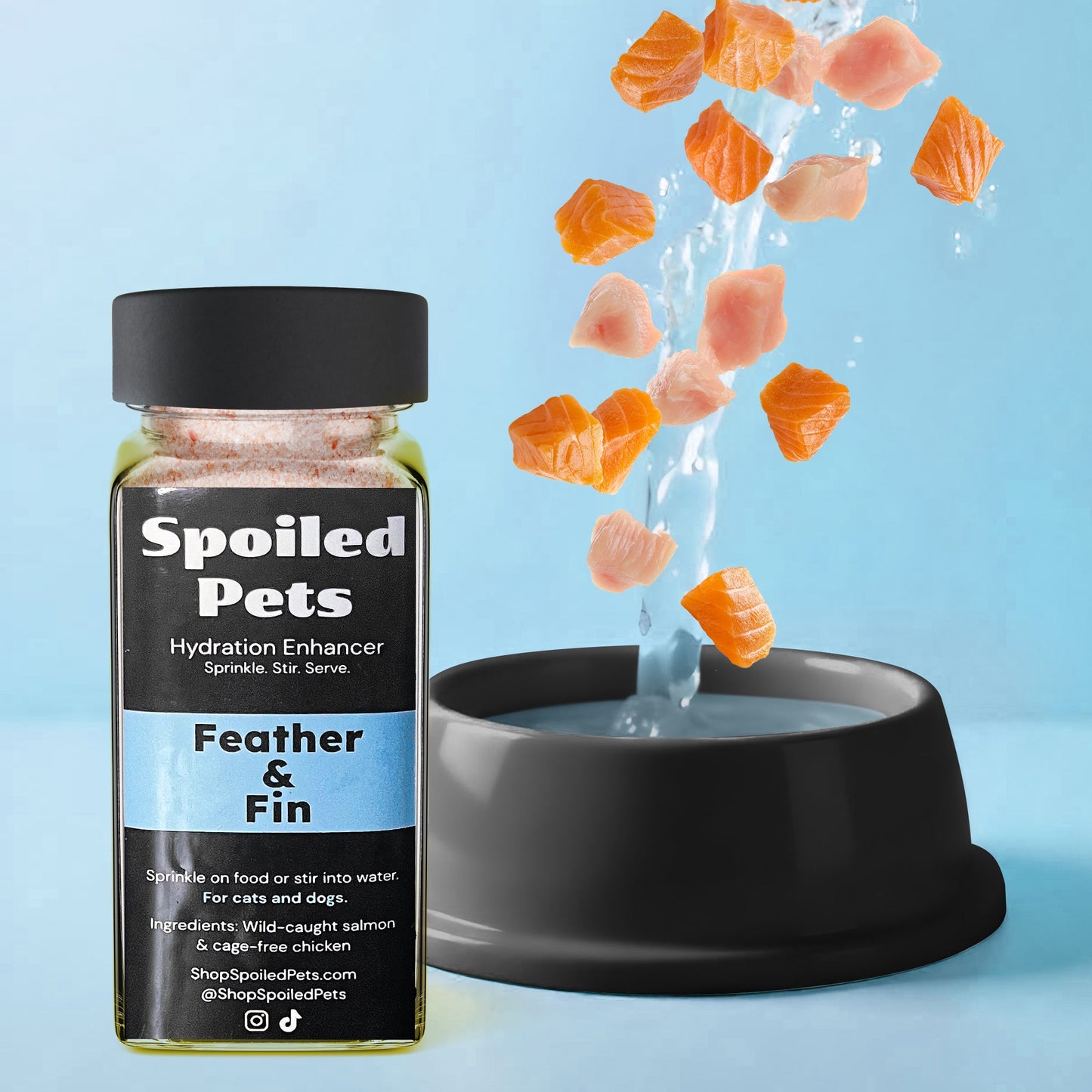 Spoiled Pets hydration enhancer bottle with salmon pieces falling into a bowl of water on a blue background