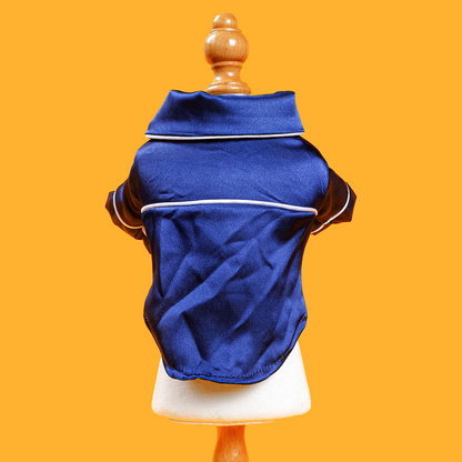 Blue pet coat on a mannequin against an orange background