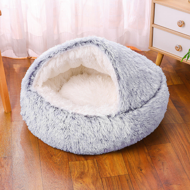 Fluffy pet bed on a wooden floor with a blurred background
