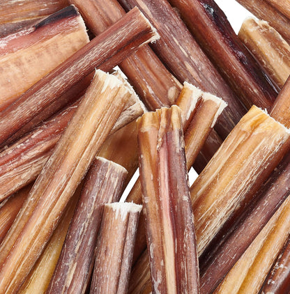 Close-up of dried dog chew sticks with a brown and beige color palette.
